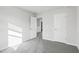 Bright bedroom with neutral walls, gray carpeting, and multiple entry points at 601 White Birch Ln, Angier, NC 27501