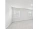 Bright bedroom with neutral carpet, white walls and two windows at 601 White Birch Ln, Angier, NC 27501