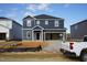 Two-story home showcasing its dark siding, white trim, and an attached two-car garage at 601 White Birch Ln, Angier, NC 27501
