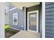 View of the front porch featuring siding and the front door of a new construction home at 601 White Birch Ln, Angier, NC 27501