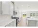 A modern kitchen with stainless steel appliances, white cabinets and backsplash, and a center island at 601 White Birch Ln, Angier, NC 27501