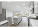 Open kitchen with an island, stainless appliances, and sliding glass doors to backyard at 601 White Birch Ln, Angier, NC 27501