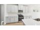 Well-lit kitchen featuring white cabinets, quartz counters, and stainless steel appliances at 601 White Birch Ln, Angier, NC 27501