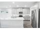 Modern kitchen featuring an island, stainless steel appliances, and gray cabinetry at 601 White Birch Ln, Angier, NC 27501