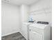 A clean, white laundry room equipped with a washer and dryer at 601 White Birch Ln, Angier, NC 27501