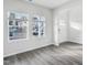 Living room with white walls, wood-look floors, and natural light from two windows at 601 White Birch Ln, Angier, NC 27501