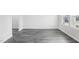 Living room with white walls, wood-look floors, and natural light from two windows at 601 White Birch Ln, Angier, NC 27501