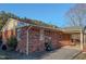 Back exterior view of a red brick home with a covered patio at 604 Orange Factory Road, Bahama, NC 27503
