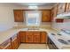 Charming kitchen with wood cabinets, double sink, and window view to outdoors at 604 Orange Factory Road, Bahama, NC 27503