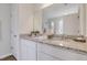 Bright bathroom with granite countertop, dual sinks, and pristine white cabinetry at 62 Atherton Circle, Angier, NC 27501