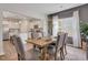 Inviting dining room features a wooden table, six upholstered chairs, and lots of natural light from the nearby window at 62 Atherton Circle, Angier, NC 27501