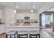 Well-lit kitchen with white cabinets, stainless steel appliances, granite countertops, and an island with bar seating at 62 Atherton Circle, Angier, NC 27501
