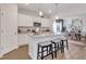 Open kitchen with granite countertops, stainless steel appliances, white cabinets, and an island with seating for casual dining at 62 Atherton Circle, Angier, NC 27501