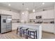 Contemporary kitchen featuring stainless steel appliances, granite countertops, white cabinets, and a functional center island at 62 Atherton Circle, Angier, NC 27501