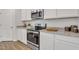 Bright kitchen features granite countertops, stainless steel appliances, white cabinets, and a modern design for efficient cooking at 62 Atherton Circle, Angier, NC 27501