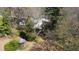 An aerial view showcasing the home's setting amongst mature trees and a quaint gazebo in the yard at 620 Sunnybrook Rd, Raleigh, NC 27610