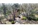 Aerial view of a charming home with mature trees and a driveway leading to Sunnybrook Road at 620 Sunnybrook Rd, Raleigh, NC 27610