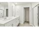 Modern bathroom featuring double sink vanity, white cabinets, and glass enclosed shower at 621 White Birch Ln, Angier, NC 27501