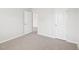 Bedroom with plush carpeting, white walls, and two white doors at 621 White Birch Ln, Angier, NC 27501