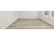 Bright, spacious room with wood-look flooring, neutral walls, and ample natural light at 621 White Birch Ln, Angier, NC 27501