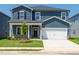Charming two-story home featuring a two-car garage, covered porch and a well-manicured lawn at 621 White Birch Ln, Angier, NC 27501