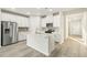 Modern kitchen with white cabinets, stainless steel appliances, a center island, and wood-look flooring at 621 White Birch Ln, Angier, NC 27501