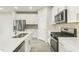 Well-equipped kitchen with stainless steel appliances, sleek white cabinetry, and a functional island at 621 White Birch Ln, Angier, NC 27501