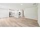 Open-concept kitchen with white cabinets, stainless steel appliances, and wood-look flooring at 621 White Birch Ln, Angier, NC 27501
