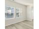 Well-lit living area featuring wood-look flooring and large windows with views of the neighborhood at 621 White Birch Ln, Angier, NC 27501