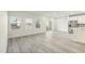 Open living space featuring wood-look flooring, modern lighting, and a view of the kitchen at 621 White Birch Ln, Angier, NC 27501