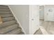 Carpeted staircase leading upstairs, complemented by wood-look flooring in the entryway at 621 White Birch Ln, Angier, NC 27501