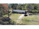 Aerial view showcases a home with a well-kept yard and private driveway surrounded by mature trees at 640 Sunnybrook Rd, Raleigh, NC 27610