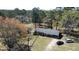 Aerial view showcasing a home with a well-kept yard surrounded by mature trees, and a private driveway at 640 Sunnybrook Rd, Raleigh, NC 27610
