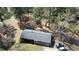 Aerial view of a well-maintained home with a gray roof, and a carport nestled among mature trees at 640 Sunnybrook Rd, Raleigh, NC 27610