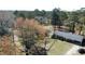 Aerial view of a charming home with mature trees and a well-kept yard in a peaceful setting at 640 Sunnybrook Rd, Raleigh, NC 27610