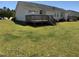 Spacious backyard featuring a wooden deck, perfect for outdoor relaxation and entertaining at 70 Ariel St, Lillington, NC 27546