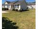 Charming home with black shutters and manicured lawn, offering a serene suburban living experience at 70 Ariel St, Lillington, NC 27546