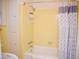 Bathroom featuring a bathtub with a shower and built-in shelving unit for convenient storage at 711 Evergreen Rd, Rocky Mount, NC 27803