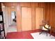 A bedroom featuring wood paneled walls, closet space, and a view through an open doorway at 711 Evergreen Rd, Rocky Mount, NC 27803