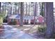 A lovely single-story brick home with a paved driveway surrounded by lush trees at 711 Evergreen Rd, Rocky Mount, NC 27803