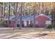 Charming one-story brick home featuring mature trees and a well-maintained lawn at 711 Evergreen Rd, Rocky Mount, NC 27803