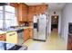 Kitchen features wood cabinets, stainless steel appliances, and eat-in nook at 711 Evergreen Rd, Rocky Mount, NC 27803