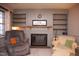Living room featuring a fireplace with built-in shelving units, plus comfortable armchairs and a guitar at 711 Evergreen Rd, Rocky Mount, NC 27803