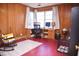 Home office with wood-paneled walls, a large window, and a desk with dual monitors for working from home at 711 Evergreen Rd, Rocky Mount, NC 27803