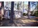 Screened-in porch attached to a brick house, surrounded by trees at 711 Evergreen Rd, Rocky Mount, NC 27803