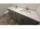 Bathroom featuring a double sink vanity with quartz countertops, gray cabinets, and modern fixtures at 766 Old Station Pointe, Angier, NC 27501