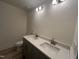 Bathroom featuring a double sink vanity with quartz countertops, gray cabinets, and modern fixtures at 766 Old Station Pointe, Angier, NC 27501
