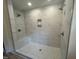 Bathroom with a tiled shower, modern fixtures, a built-in niche, and a shower seat at 766 Old Station Pointe, Angier, NC 27501