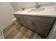 Bathroom featuring a double sink vanity with quartz countertops, gray cabinets, and modern fixtures at 766 Old Station Pointe, Angier, NC 27501