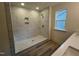 Bathroom with a tiled, zero entry shower, modern fixtures, a built-in niche, and quartz countertops at 766 Old Station Pointe, Angier, NC 27501